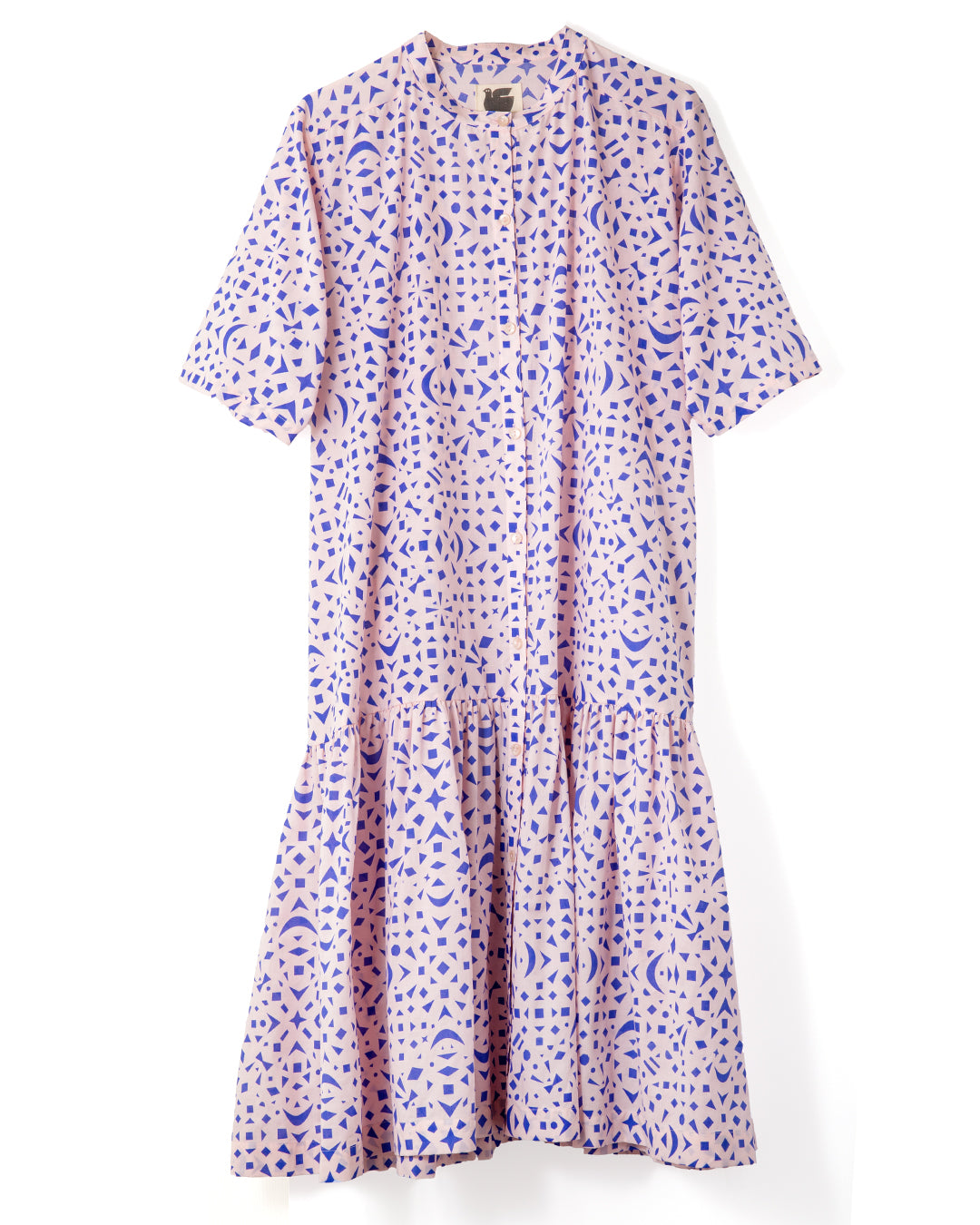 Short-sleeve dress with cobalt blue snowflake pattern on a soft peach cotton