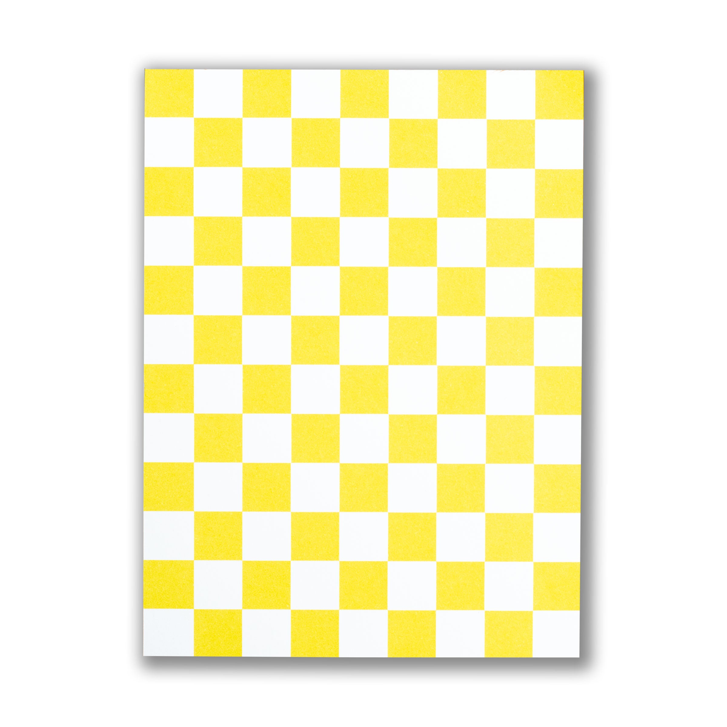 Checkered patterned notepad with yellow and white squares on a white background