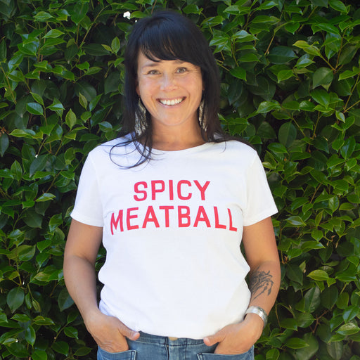 This woman is so happy, she got to eat spaghetti and meatballs for lunch, and now she is wearing the cutest t-shirt that says Spicy Meatball in red type