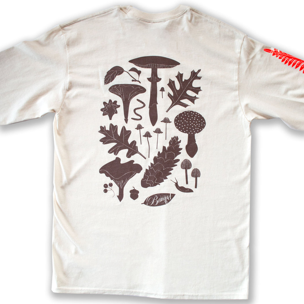 long sleeved shirt printed with a brown moth, neon red fern and snail, and lavender mushroom