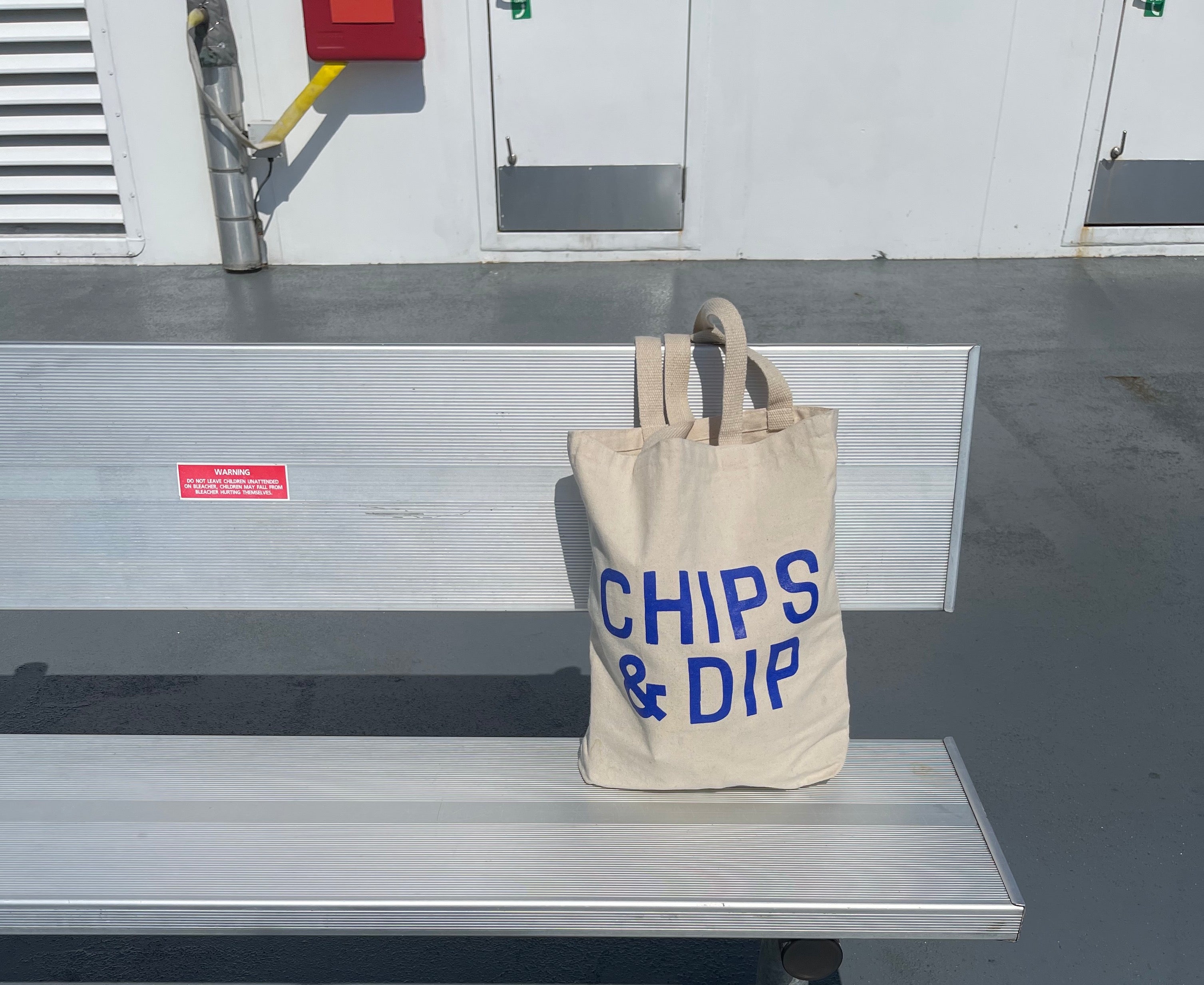 Chips and Dip tote bag on a metal seat on a ferry