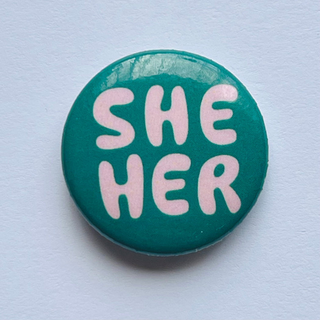 Pronoun pin, she/her button, blush and green 