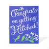 Greeting card with 'Congrats on getting hitched!' text on a blue background