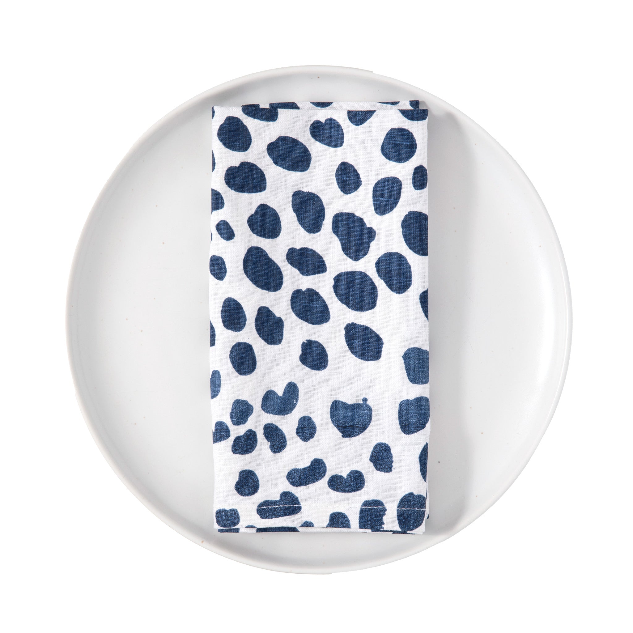 Napkin with blue abstract pattern on a white plate