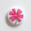 tiny cosmos flower on a 1" round button