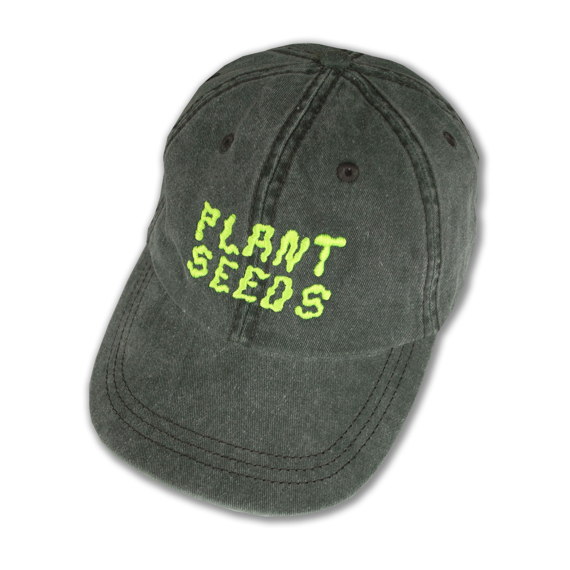 khaki ball cap embroidered in wiggly neon yellow letters that read Plant Seeds