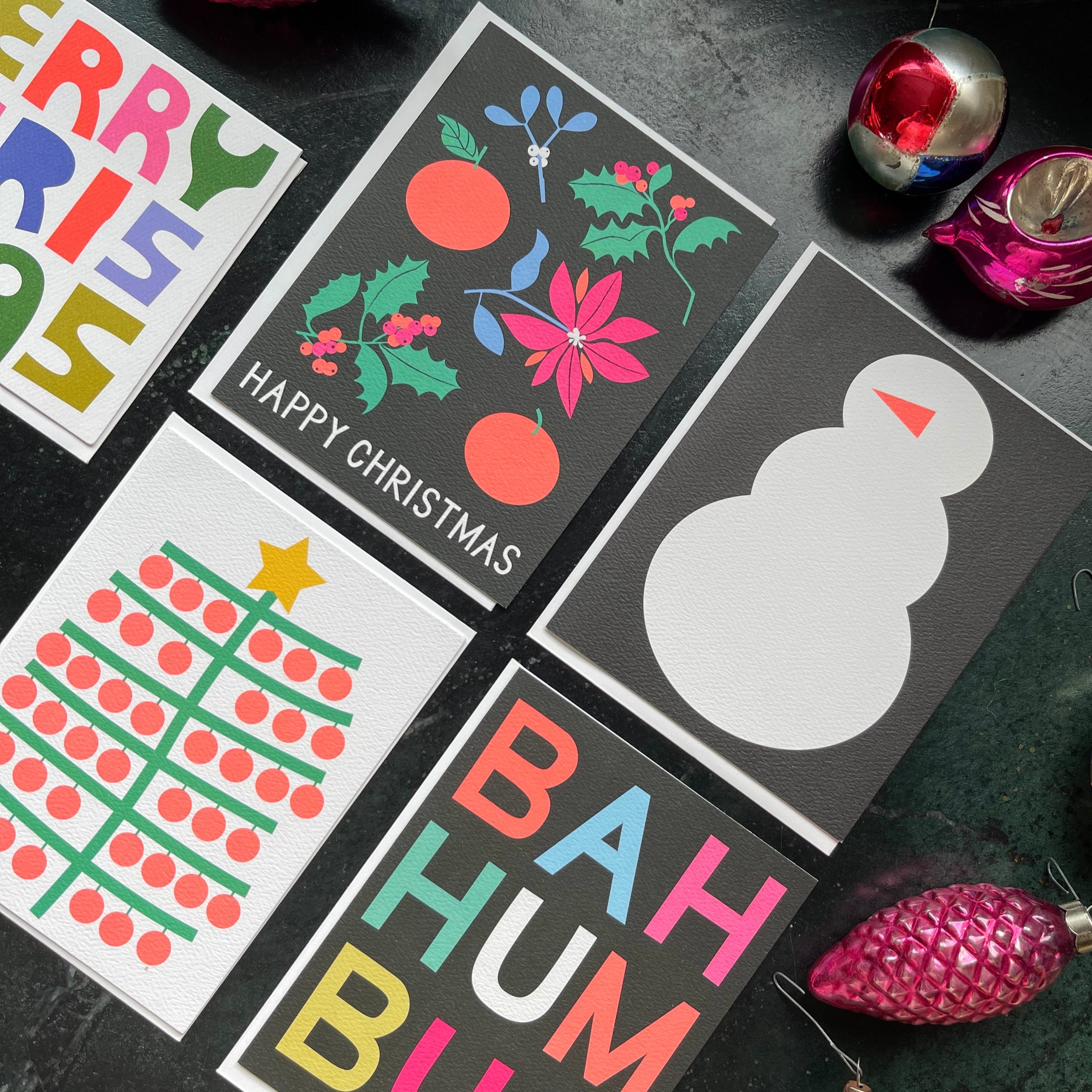 colourful holiday cards on a dark background