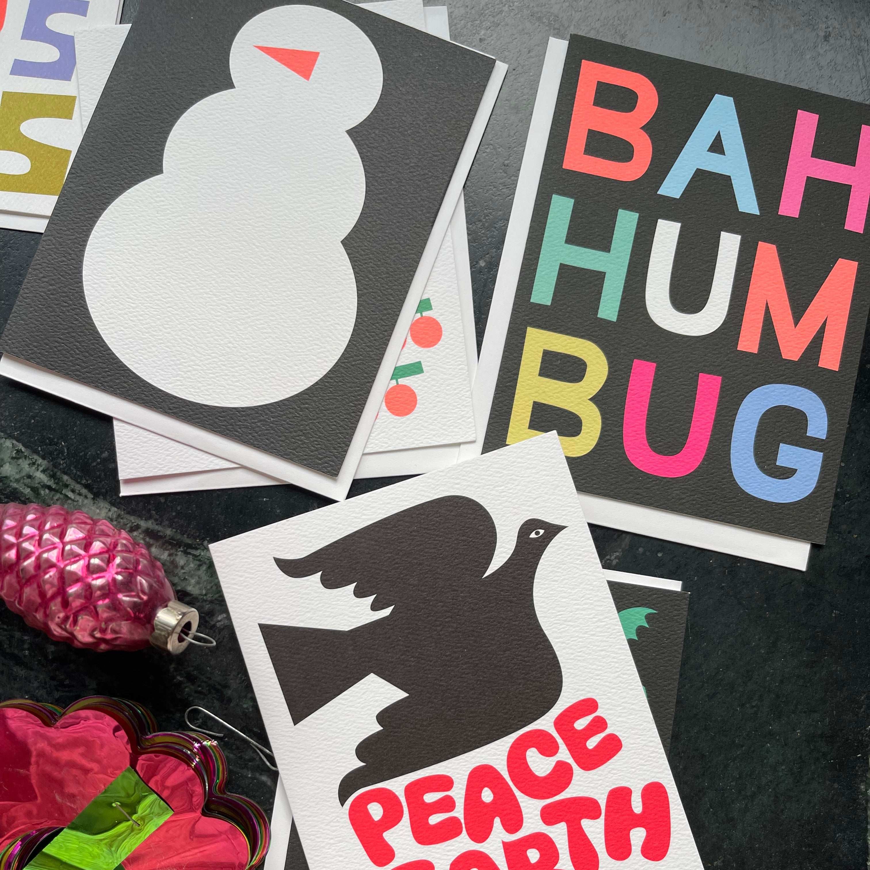 Graphic holiday Cards from Banquet Workshop on a dark stone background