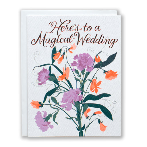 lavender and neon orange carnations and sweet peas on a card that reads "here's to a magical wedding"