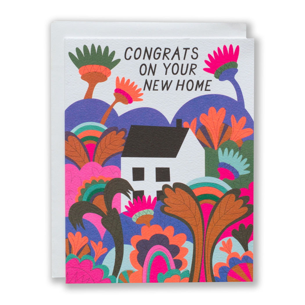 Housewarming card with an illustration of a tiny white house tucked in the middle of a psychedleic garden and the message Congrats on your new home