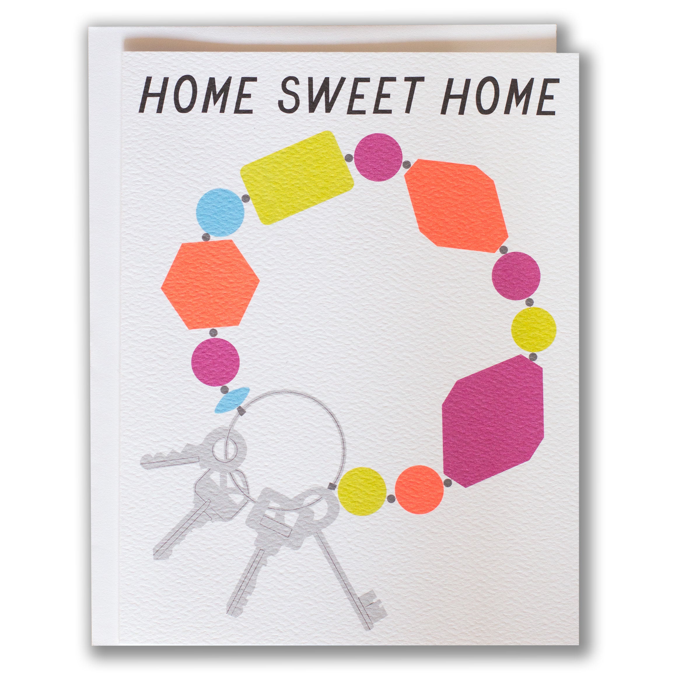 Greeting card with colorful geometric key ring and keys, featuring 'Home Sweet Home' text.