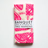 neon pink napkins printed with moths on white linen