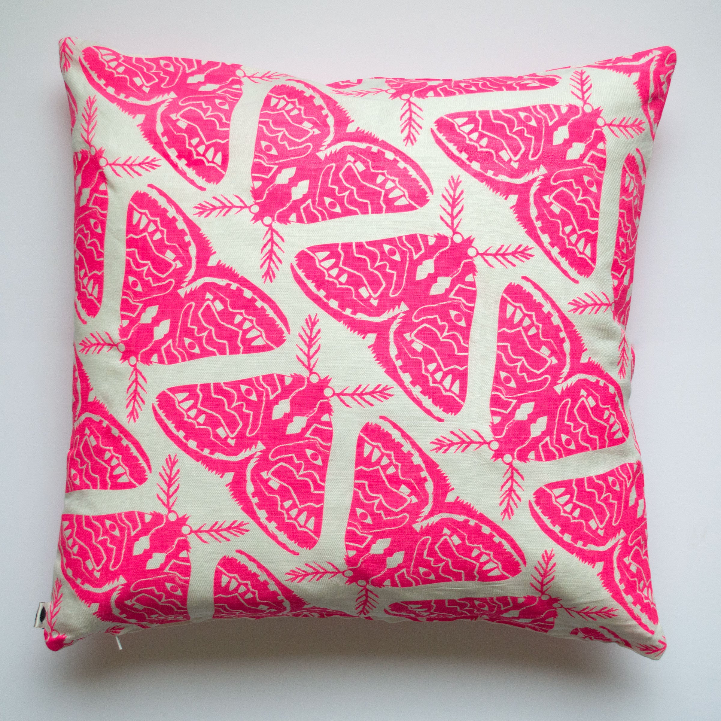 beautiful almost hand sized neon pink moth repeat print in a pillow cover