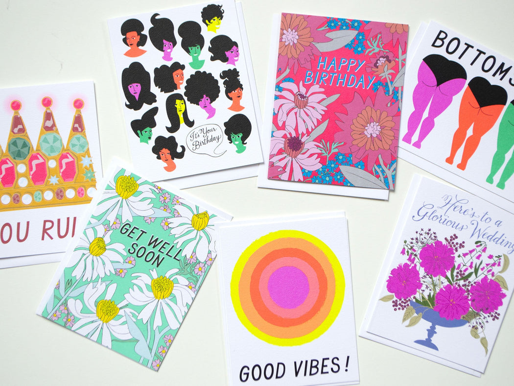 an assortment of birthday cards wedding cards and friendship with bright colours and neons