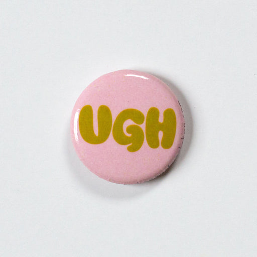 UGH in mustard bubble letters on a 1 inch blush pink pin
