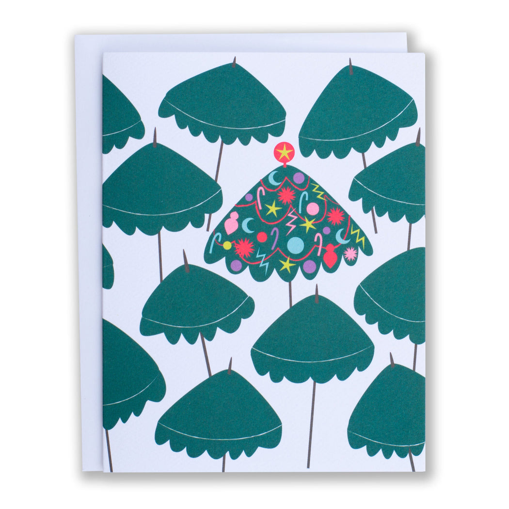 crowded green beach umbrellas with one decorated with holiday ornaments