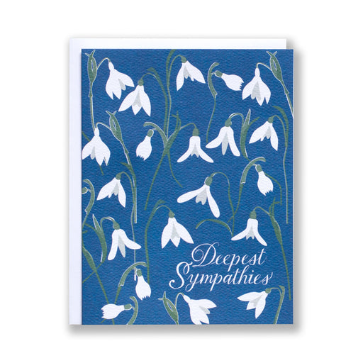 white snowdrops on a blue background on a sympathy card