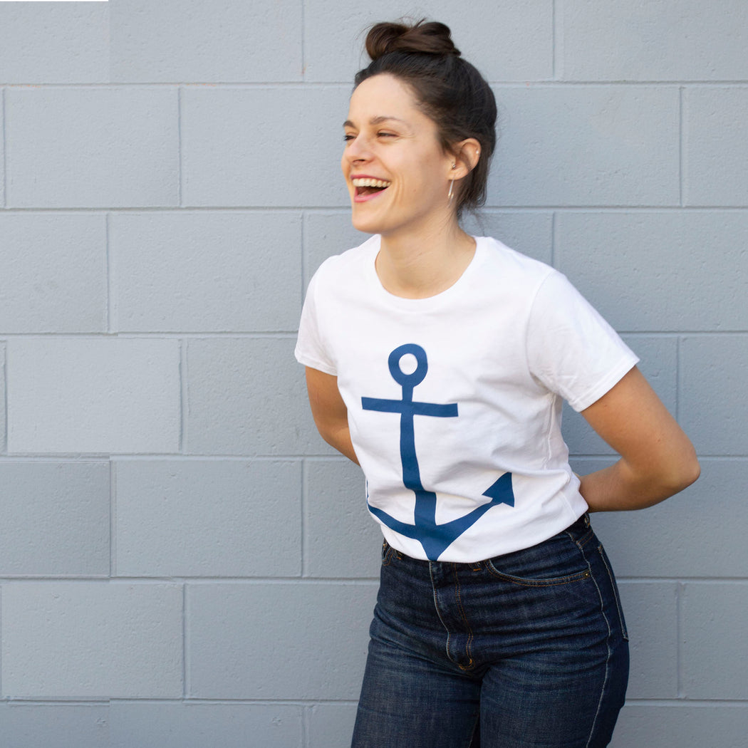 model wearing a white t-shirt with a navy anchor screen print