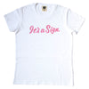 white t-shirt screen printed with "It's a Sign" in pink on pink cursive