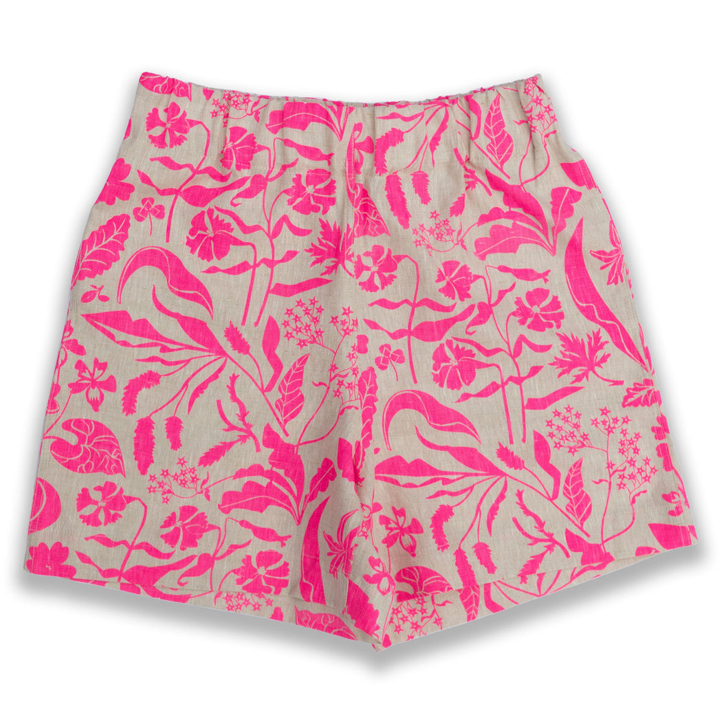 woman's linen shorts printed with a repeating pattern of neon pink spring wildflowers