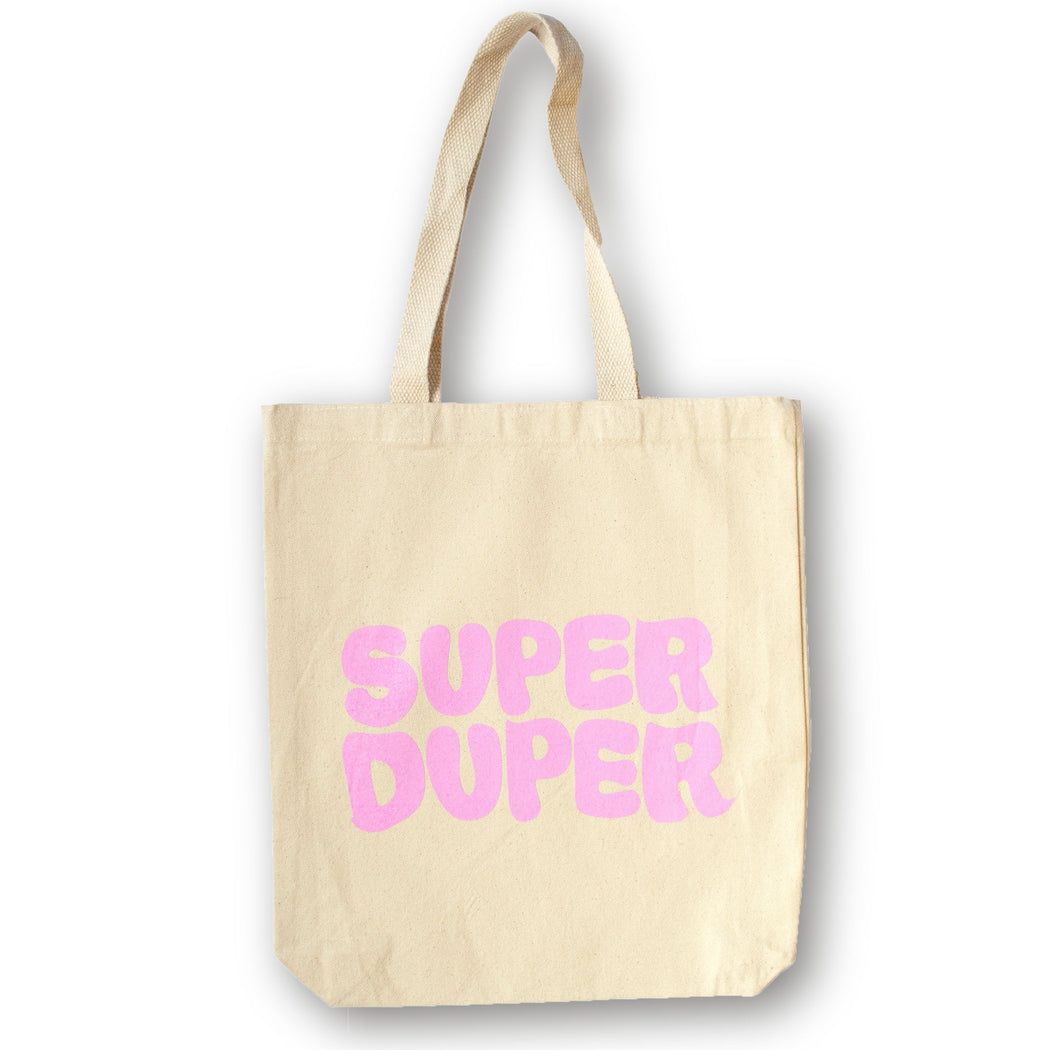 Pink SUPER DUPER in bubble letters on a natural canvas tote bag